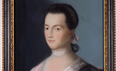 A portrait of Abigail Adams, who wears a pearl necklace and a dress with a lace collar